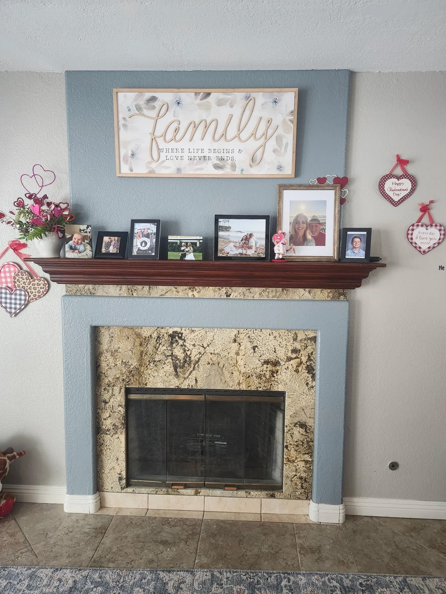 Living room with stone fireplace, mantel, and refreshed walls