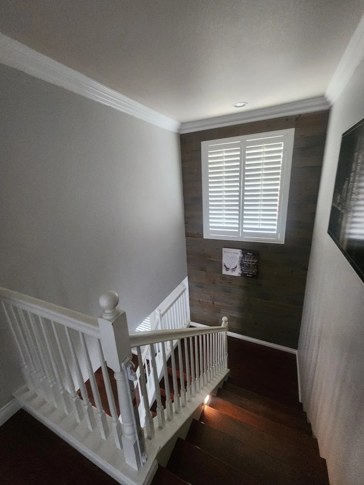 Two-story staircase landing with crown molding